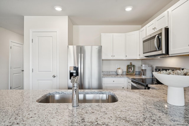 228 Camden Dr, Waynesboro, VA 22980 - kitchen featuring stainless steel appliances, white cabinetry, light stone countertops, and recessed lighting