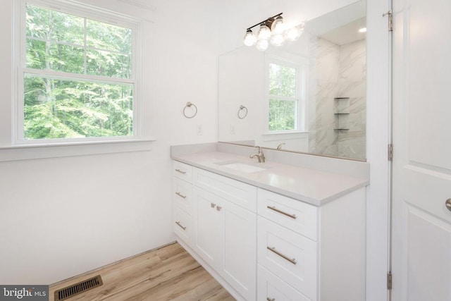 29 Dove Ct, Bumpass, VA 23024 - bathroom featuring vanity, wood finished floors, and a shower