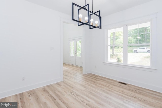 29 Dove Ct, Bumpass, VA 23024 - unfurnished dining area featuring light wood-type flooring and a chandelier