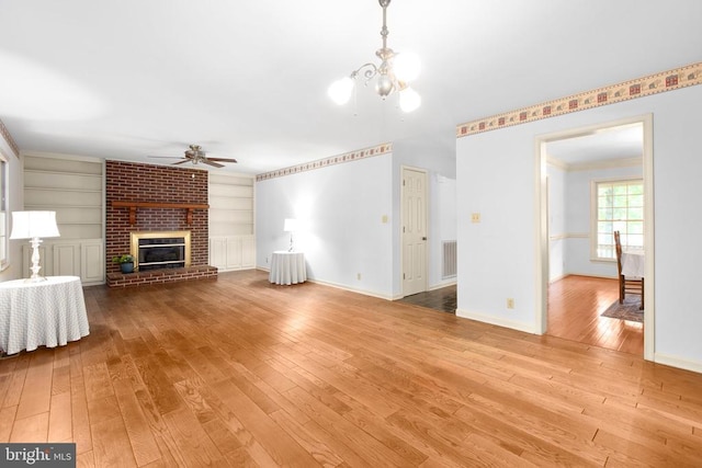 411 Laurel Ave, Fredericksburg, VA 22408 - unfurnished living room with hardwood / wood-style floors, a ceiling fan, a brick fireplace, a chandelier, and built in features