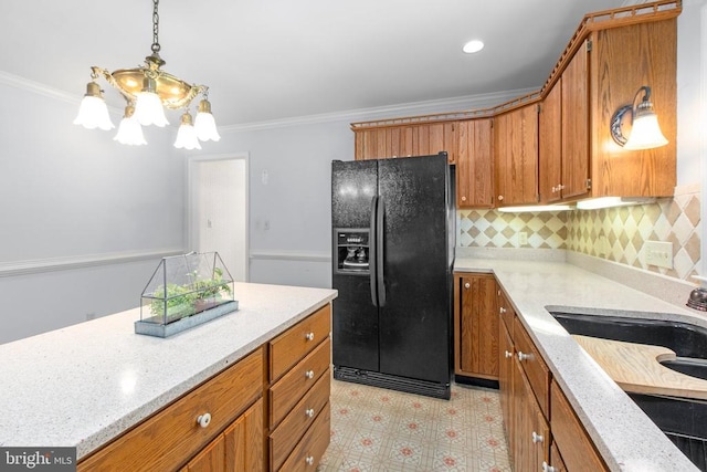 411 Laurel Ave, Fredericksburg, VA 22408 - kitchen with black refrigerator with ice dispenser, a chandelier, brown cabinets, crown molding, and light flooring