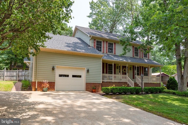 411 Laurel Ave, Fredericksburg, VA 22408 - view of front facade featuring covered porch, an attached garage, concrete driveway, and a shingled roof