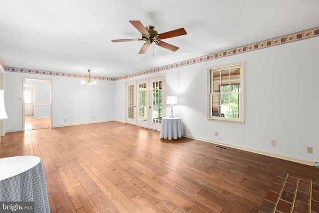 411 Laurel Ave, Fredericksburg, VA 22408 - unfurnished room featuring french doors, a ceiling fan, light wood-type flooring, and a chandelier