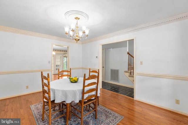 411 Laurel Ave, Fredericksburg, VA 22408 - dining room featuring a chandelier, wood finished floors, stairs, and ornamental molding