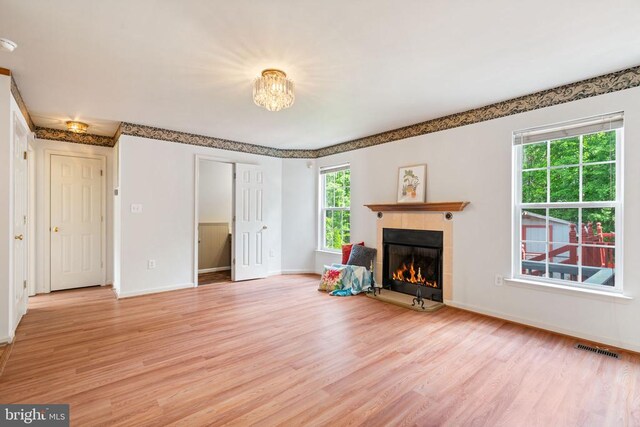4117 Dartmoor Ct, Fredericksburg, VA 22408 - unfurnished living room with light wood finished floors, a tile fireplace, and baseboards