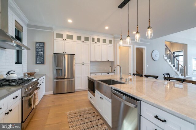 3 Carrs Bridge Rd, Lake Anna, Bumpass, VA 23024 - kitchen with stainless steel appliances, wall chimney range hood, a sink, decorative backsplash, and ornamental molding