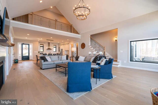 3 Carrs Bridge Rd, Lake Anna, Bumpass, VA 23024 - living room with high vaulted ceiling, stairs, a chandelier, light wood finished floors, and baseboards