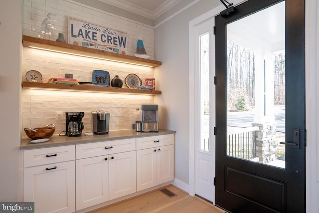 3 Carrs Bridge Rd, Lake Anna, Bumpass, VA 23024 - bar area with ornamental molding, decorative backsplash, healthy amount of natural light, and light wood-style floors