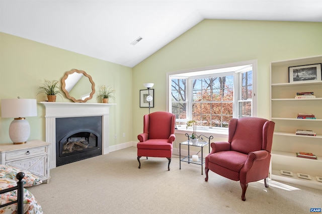 living area featuring visible vents, a fireplace, lofted ceiling, and carpet floors