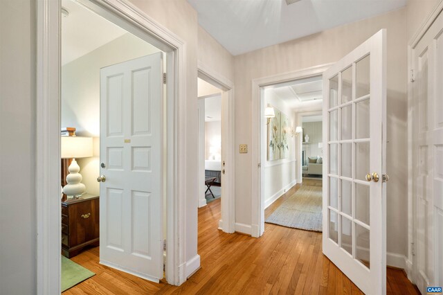 hall with light wood finished floors and baseboards