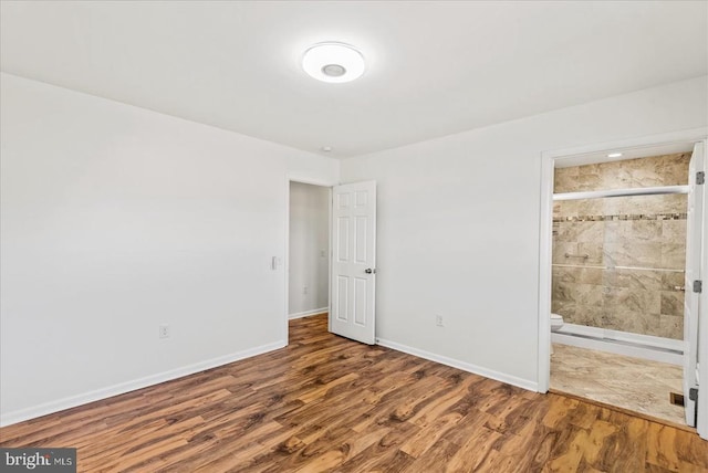 6054 Ridgeview Rd, Madison, VA 22727 - unfurnished bedroom featuring wood finished floors, baseboards, and ensuite bath