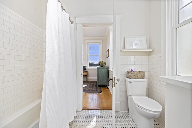 1311 N Augusta St Unit 6, Staunton, VA 24401 - bathroom with tile walls, toilet, tile patterned floors, wainscoting, and shower / tub combo