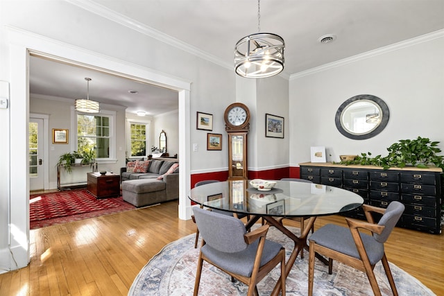 1311 N Augusta St Unit 6, Staunton, VA 24401 - dining space with plenty of natural light, light wood-type flooring, ornamental molding, and a chandelier