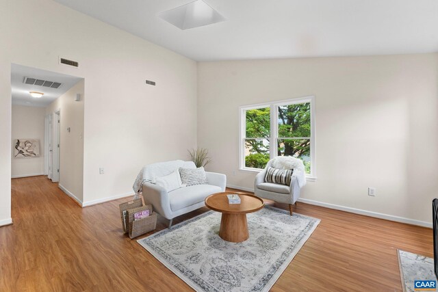 941 Warwick Ct, Charlottesville, VA 22901 - sitting room with light wood-style floors, vaulted ceiling, and a skylight
