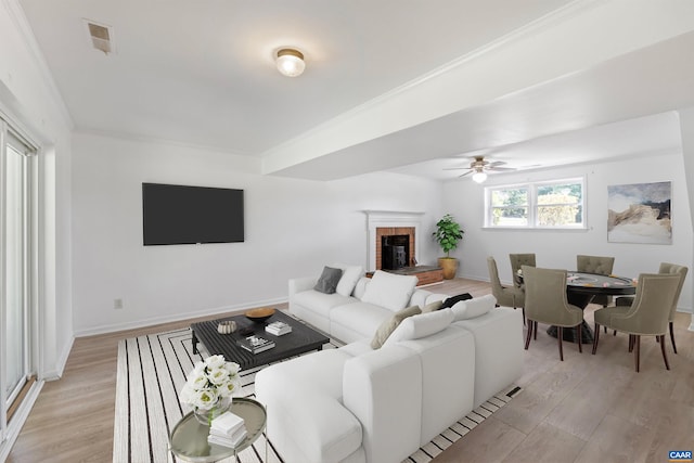 2612 Lawrence Rd, Charlottesville, VA 22901 - living area with light wood-type flooring, ceiling fan, a brick fireplace, and crown molding