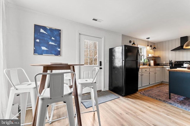 1195 Quaker Run Rd, Madison, VA 22727 - dining room featuring light wood-style floors, ornamental molding, and wooden walls