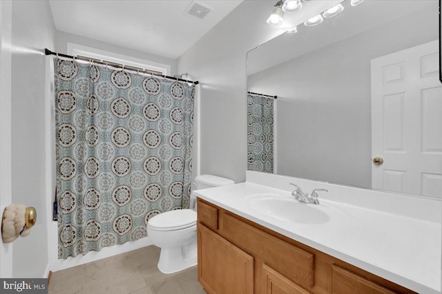 bathroom featuring vanity, toilet, and visible vents
