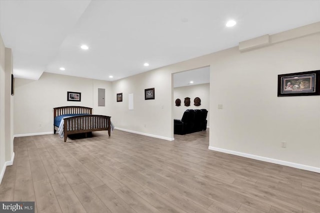 bedroom with recessed lighting, baseboards, light wood-style flooring, and electric panel