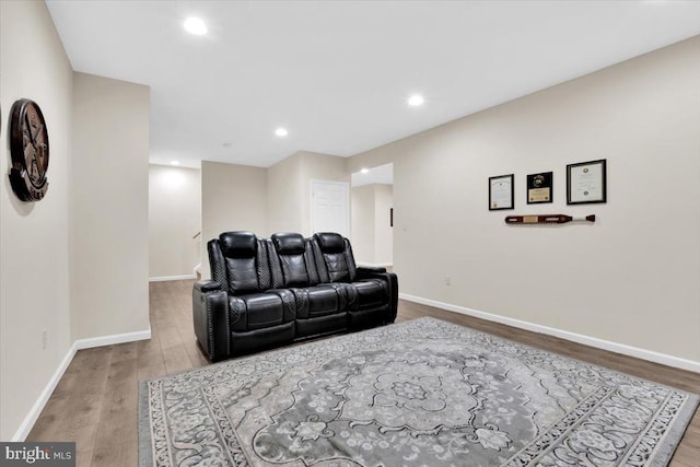 living area with baseboards, recessed lighting, and wood finished floors