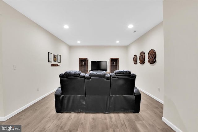 home theater room featuring recessed lighting, baseboards, and light wood-type flooring