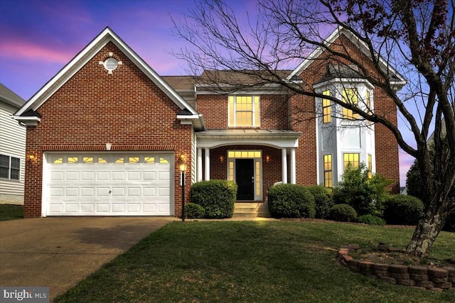 traditional home with an attached garage, driveway, a front lawn, and brick siding