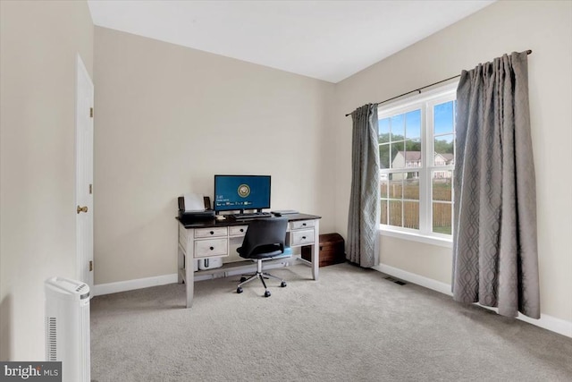 carpeted office space featuring baseboards and visible vents