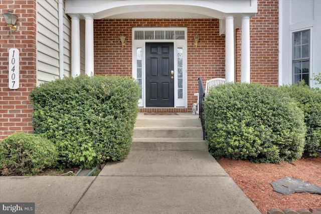 property entrance with brick siding