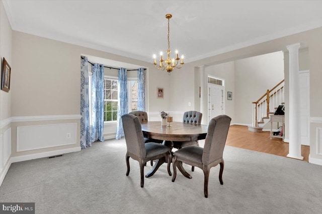 dining space with carpet flooring, a chandelier, visible vents, ornamental molding, and stairway
