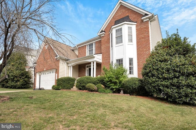 traditional-style house featuring brick siding, an attached garage, and a front yard