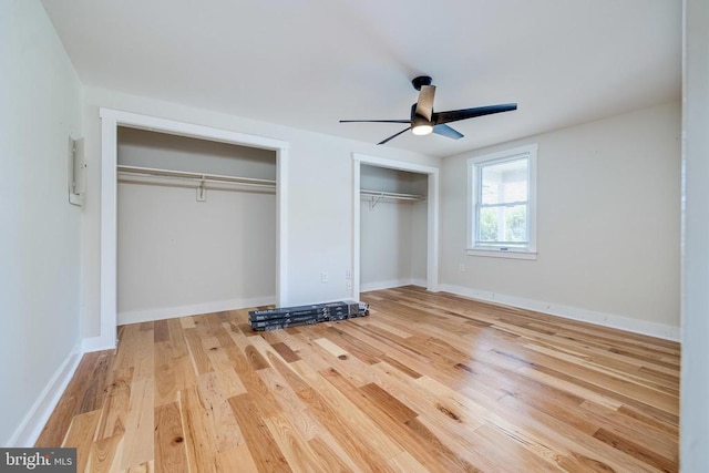 102 Hawksbill St S, Luray, VA 22835 - unfurnished bedroom with multiple closets, wood finished floors, baseboards, and ceiling fan