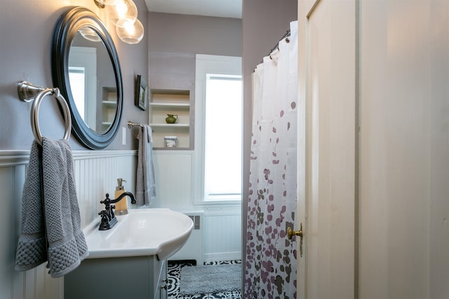 222 Main St, Dayton, VA 22821 - full bath with wainscoting, vanity, and a decorative wall