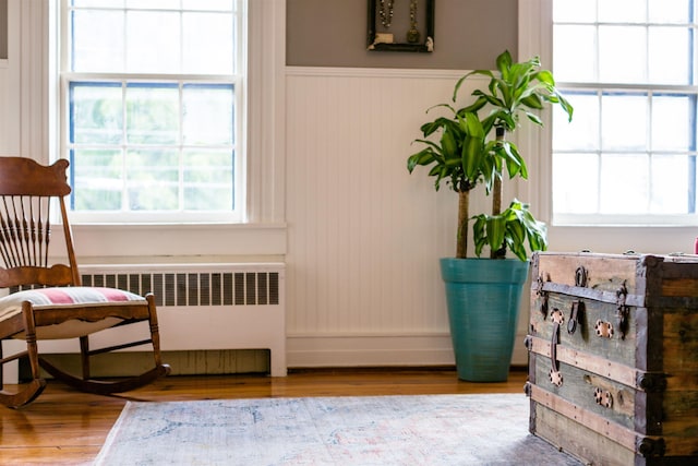 222 Main St, Dayton, VA 22821 - living area with radiator heating unit, plenty of natural light, wainscoting, and wood finished floors
