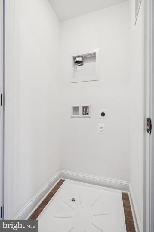 clothes washing area with washer hookup, hookup for an electric dryer, baseboards, and dark wood finished floors