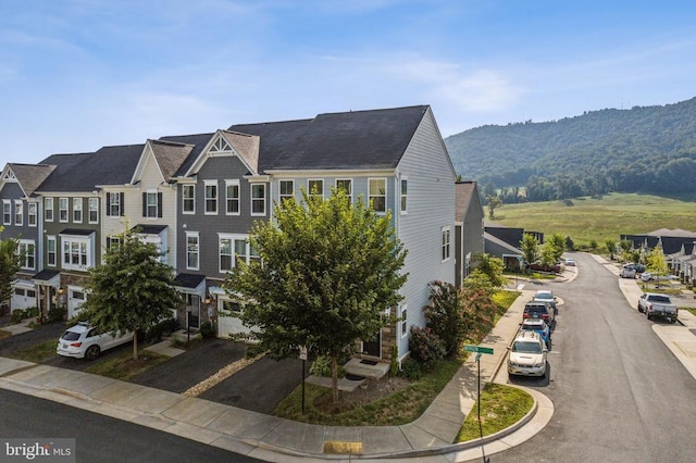 view of front of property with a mountain view and a residential view