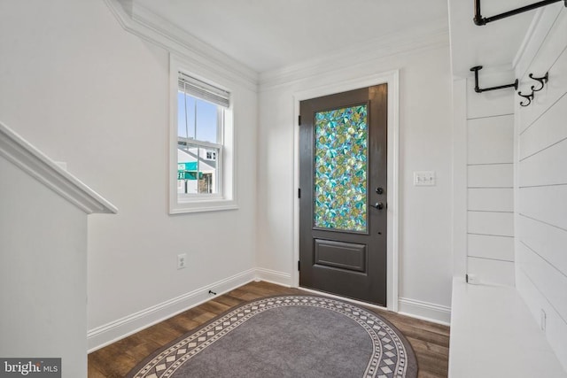 entryway with wood finished floors, baseboards, and crown molding