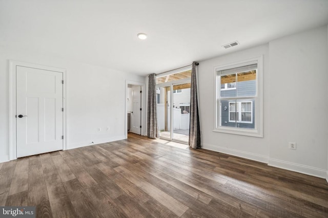 unfurnished bedroom with dark wood-type flooring and baseboards