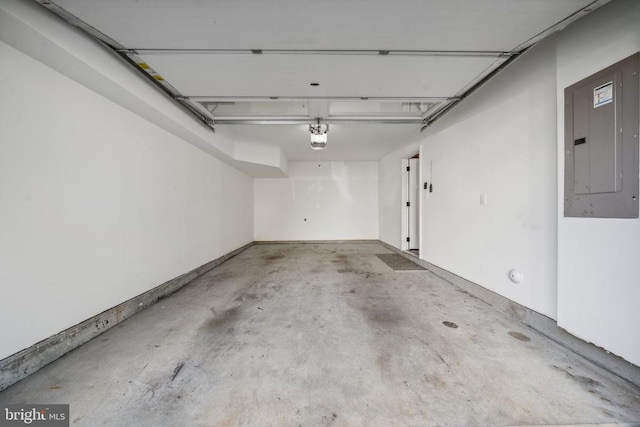 garage featuring electric panel and a garage door opener