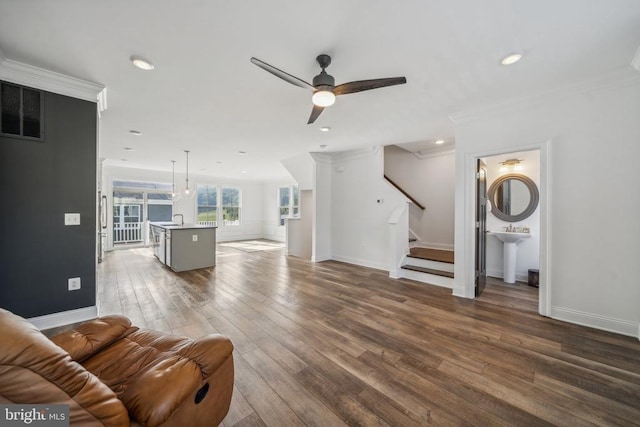 living room with a ceiling fan, stairway, wood finished floors, baseboards, and recessed lighting
