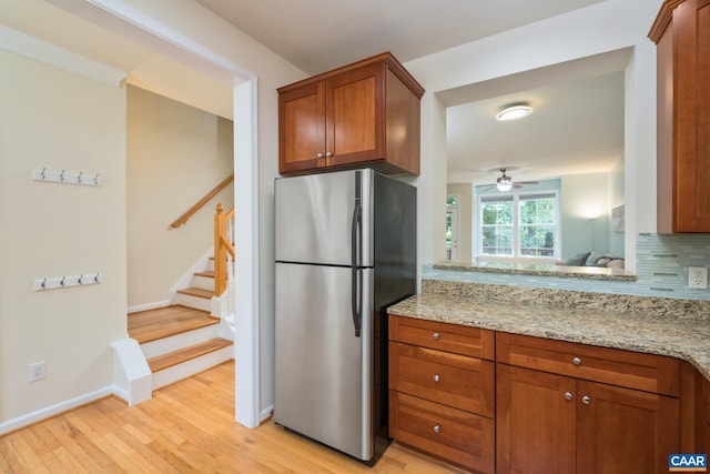 100 Melbourne Prk Cir Unit B, Charlottesville, VA 22901 - kitchen featuring freestanding refrigerator, brown cabinetry, light wood finished floors, and ceiling fan