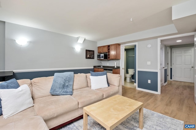 100 Melbourne Prk Cir Unit B, Charlottesville, VA 22901 - living area with light wood-style floors and wet bar