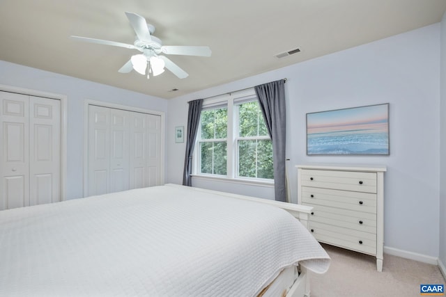 100 Melbourne Prk Cir Unit B, Charlottesville, VA 22901 - bedroom with multiple closets, light carpet, and ceiling fan
