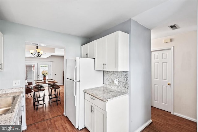 2211 Rock Creek Rd, Fredericksburg, VA 22407 - kitchen featuring wood finished floors, a chandelier, white cabinets, and freestanding refrigerator