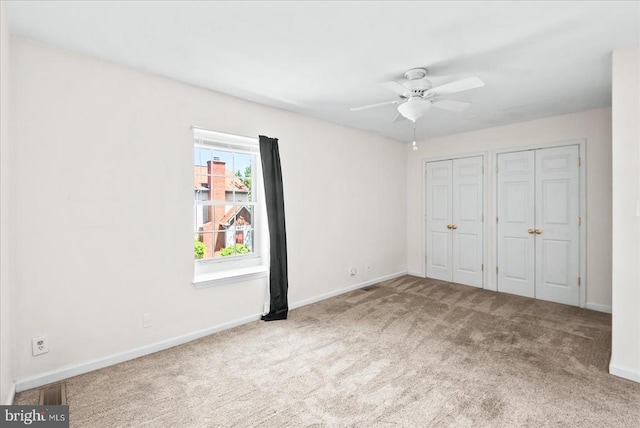 2211 Rock Creek Rd, Fredericksburg, VA 22407 - unfurnished bedroom featuring carpet flooring, multiple closets, baseboards, and ceiling fan
