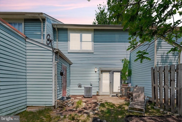 2211 Rock Creek Rd, Fredericksburg, VA 22407 - back of property at dusk featuring fence and central air condition unit
