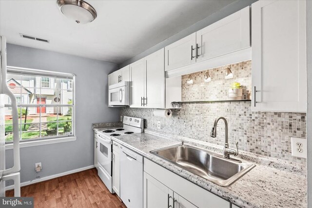 2211 Rock Creek Rd, Fredericksburg, VA 22407 - kitchen featuring white appliances, a sink, decorative backsplash, white cabinets, and light wood finished floors