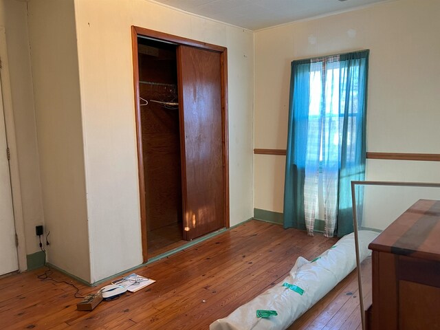 bedroom with hardwood / wood-style flooring and a closet