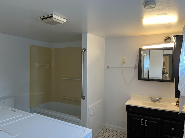 full bathroom featuring toilet, vanity, shower / tub combination, separate washer and dryer, and baseboards