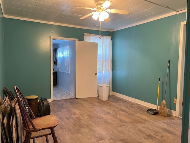 bedroom with baseboards, wood finished floors, connected bathroom, and crown molding