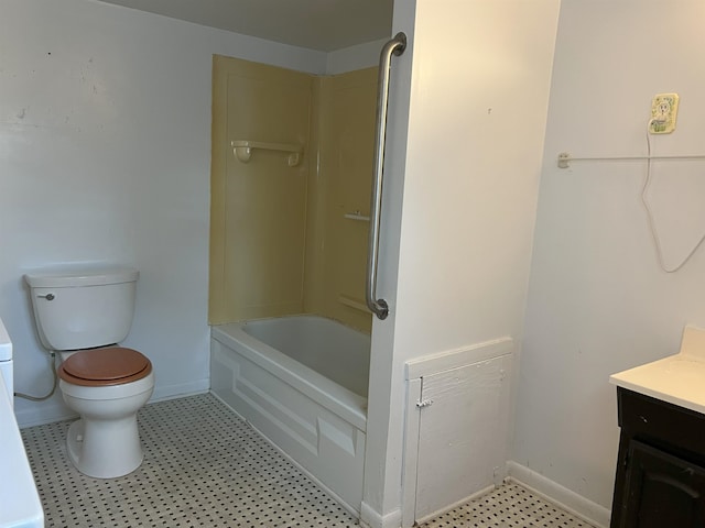 bathroom with bathing tub / shower combination, vanity, toilet, and baseboards