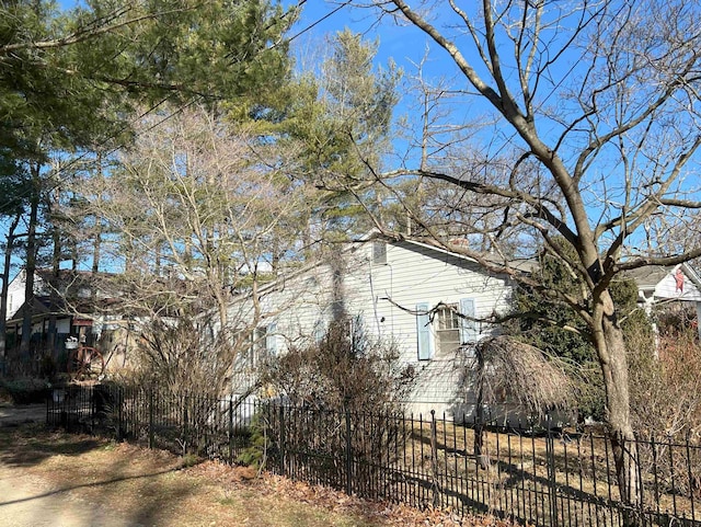 view of side of home with a fenced front yard